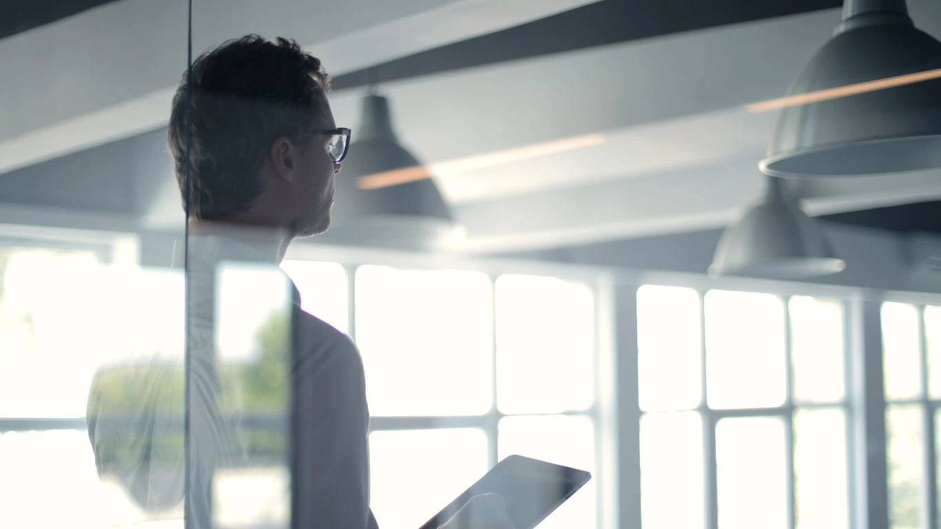 Executive looking at tablet in modern office